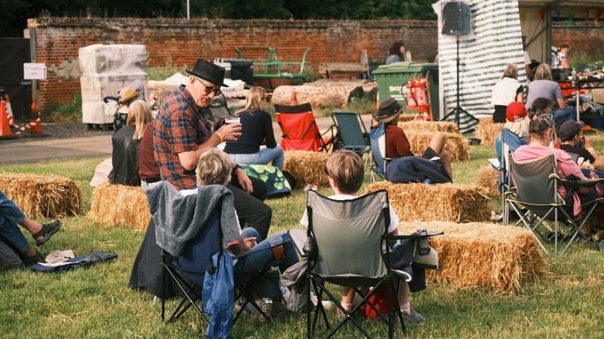 Image of people sitting and talking outdoors