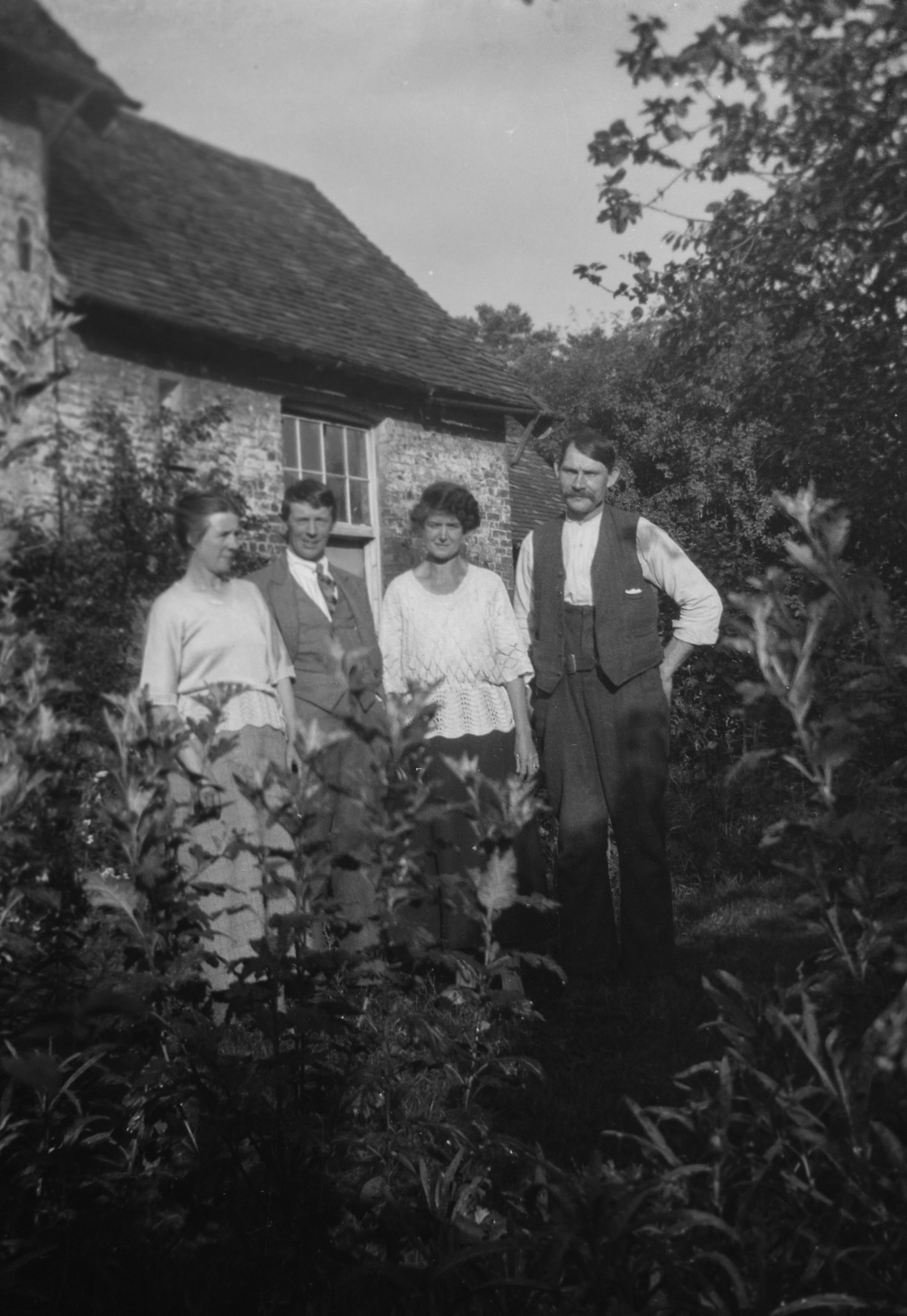 Black and white picture with four people standing together